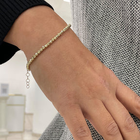 Goldenes Armband mit geschliffenen Goldkugeln. Luxuriöses Accessoire für stillvolle Eleganz, Imagebild